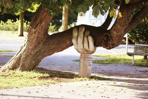 a sculpture of a hand holding a tree