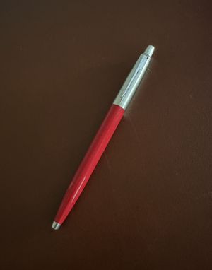 A red Parker Jotter pen